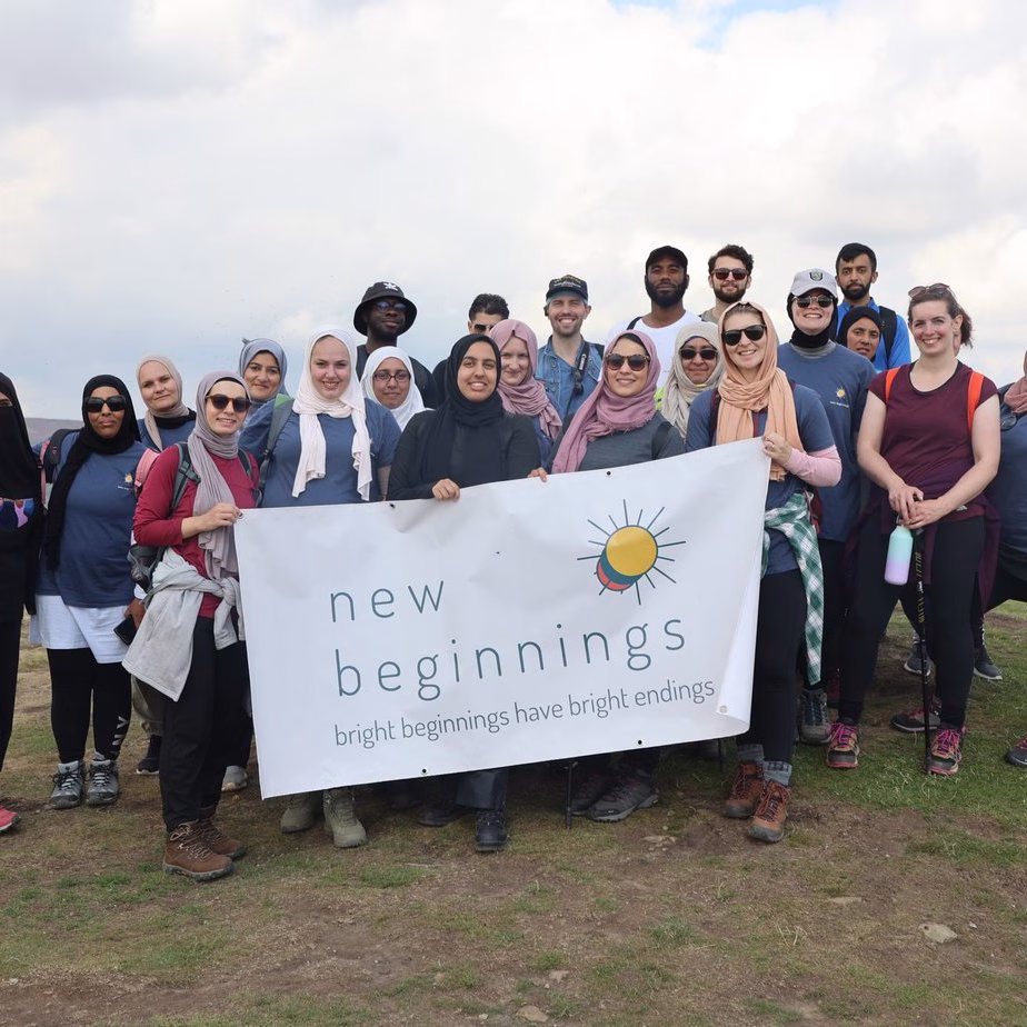 137A1161 A New Beginnings group holding the charity banner on an outdoor walk